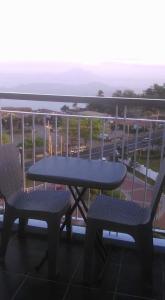 uma mesa e cadeiras numa varanda com vista para o oceano em The Perfect Getaway em Tagaytay