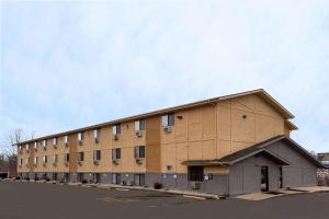 a large brown building with a sky in the background at Super 8 by Wyndham Dubuque in Dubuque