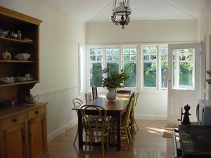 a dining room with a table and chairs in a kitchen at Captain Lock's Cottage in Rhyll