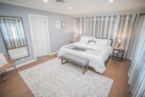 a bedroom with a large bed and a rug at Enchanting Sherman Oaks Home With Pool permit #HSR two one zero zero 2605 in Sherman Oaks