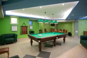 a pool table in a room with green walls at Business Hotel Europa in Khabarovsk