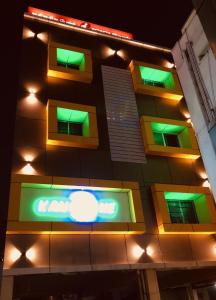 a building with green lights on the side of it at Kans One in Chennai