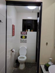 a bathroom with a white toilet and a sink at Anabelle Residence in Dumaguete