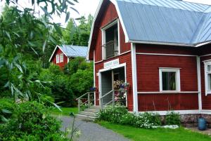 a red house with a metal roof at Villa Dönsby in Karjaa