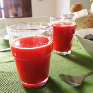 two glasses of red juice sitting on a table at Residenza Terrazze sul Mare in Santa Flavia
