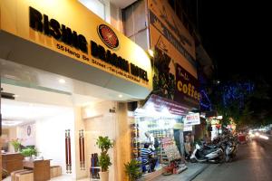 a store with a sign on the side of a street at Rising Dragon Legend Hotel in Hanoi