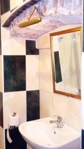a bathroom with a sink and a mirror at Apartman i Sobe Čule Cres in Cres