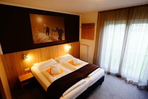 Postel nebo postele na pokoji v ubytování Fairhotel Hochfilzen B&B