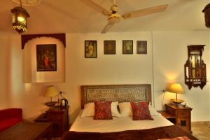 a bedroom with a bed with red pillows at Yogis Guest House in Jodhpur +98 photos
