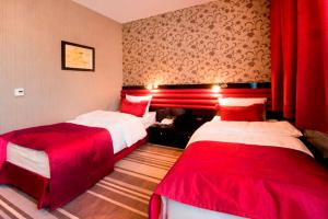 Voodi või voodid majutusasutuse Hotel Symfonia Osjaków toas