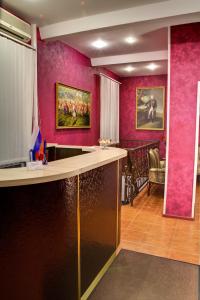 a bar in a room with pink walls at Suvorovskaya Hotel in Moscow