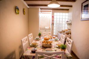 a dining room table with a table cloth with food on it at Casinha D'Avó Guesthouse in Lagos