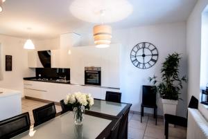 a kitchen and dining room with a vase of flowers on a table at Villa Rosa in Argegno