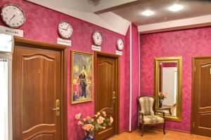 a waiting room with clocks on the walls at Suvorovskaya Hotel in Moscow
