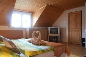 a bedroom with a bed with a towel on it at Rekreacny Dom in Strečno