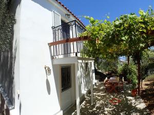 a side view of a white house with a table at Villas Zoe in Skiathos