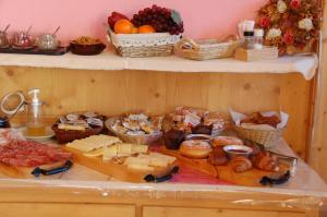 a table topped with lots of different types of food at Hotel Carpe Diem in Livigno