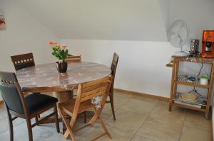 uma mesa de jantar e cadeiras com um vaso em Hirschfarm, Goldau em Goldau