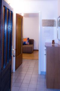 a hallway with a kitchen and a living room at Apartman Đina in Risika +3 photos