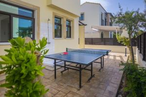 a ping pong table in the backyard of a house at Villa Mylos 8 in Protaras