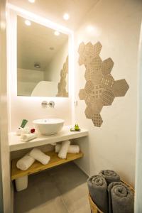 a bathroom with a sink and a mirror at Ethereum Luxury Cave in Imerovigli