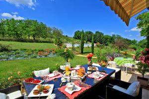 a table with food on it on a patio at Les Chenes Rouges in Veyrines-de-Domme