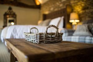 a wicker basket sitting on a table in a bedroom at The Porch House in Stow on the Wold