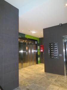a public restroom with a walk in shower at Apartamentos Clarín in Oviedo