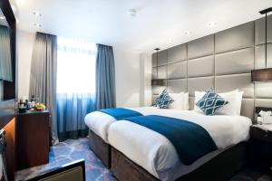 a hotel room with a bed and a desk at The Chilworth London Paddington in London