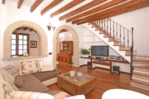 a living room with a couch and a tv at Convent House in Alcudia