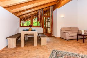 a living room with a table and a couch at Haus Traudi in Nova Ponente