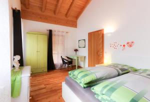 a bedroom with a bed and a desk at Haus Traudi in Nova Ponente