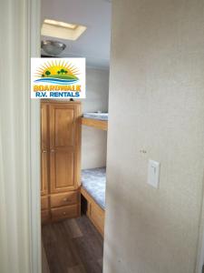 a hallway with a room with a ryan francis sign at Boardwalk RV Rental (Site #14) in Cavendish