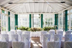 Cette chambre comprend des chaises blanches, des tables et des fleurs. dans l'établissement The Eagle House Hotel, à Launceston
