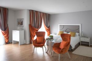 a living room filled with furniture and a table at Grand Hotel Trieste & Victoria in Abano Terme