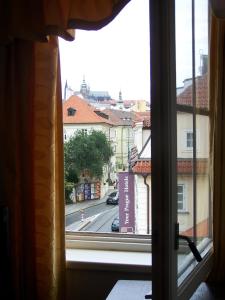 a view of a city street from a window at Hotel U Kříže in Prague