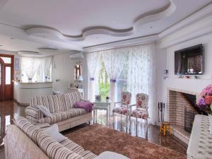 a living room with two couches and a fireplace at Pousada Perfume de Canela in Canela