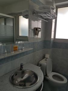 a bathroom with a sink and a toilet at Xenia Hotel Drama in Drama