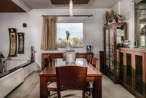 a dining room with a table and chairs and a window at Villa Doro Thassos in Limenas