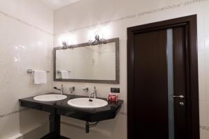 a bathroom with a sink and a mirror at Hotel Pegas in Krasnodar