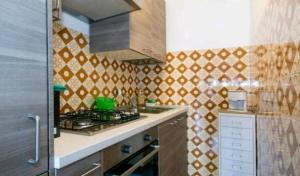 a kitchen with a stove and a counter top at House Carla in Bellano