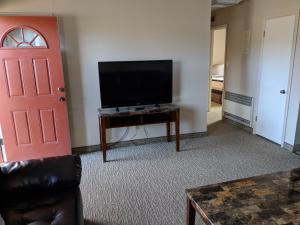 
a living room filled with furniture and a tv at Red Rock Motel in Page
