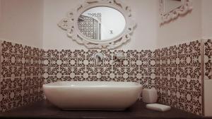 a bathroom with a white tub and a mirror at Arbanella in Corniglia +37 photos