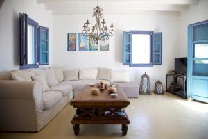 a living room with a couch and a coffee table at Luxury house in the island of Patmos in Grikos