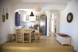 cocina con mesa y nevera en Luxury house in the island of Patmos en Grikos