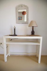 a white desk with a lamp and a mirror at Luxury house in the island of Patmos in Grikos
