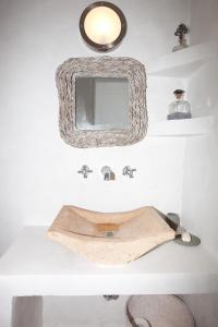 a bathroom with a sink and a mirror on a counter at Luxury house in the island of Patmos in Grikos