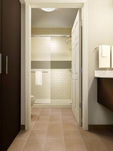 a bathroom with a walk in shower next to a toilet at Staybridge Suites Miamisburg, an IHG Hotel in Miamisburg