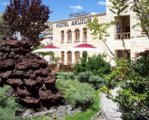 a hotel with a garden in front of a building at Akuzun Stone Hotel in Ürgüp