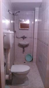 a bathroom with a toilet and a sink at Hotel Tony in Nesebar